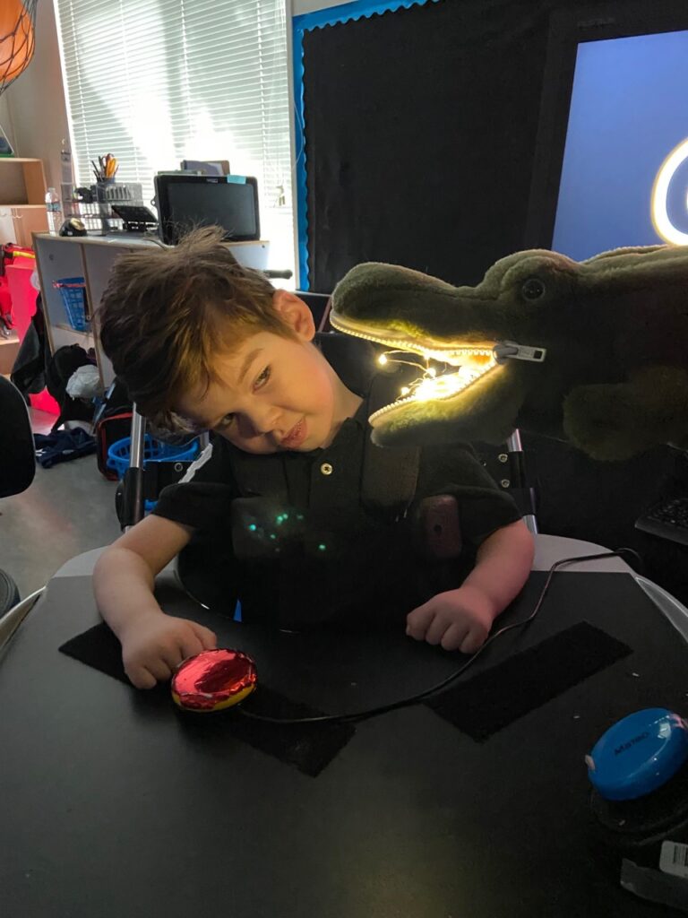 young boy with a disability interacts with an educational toy